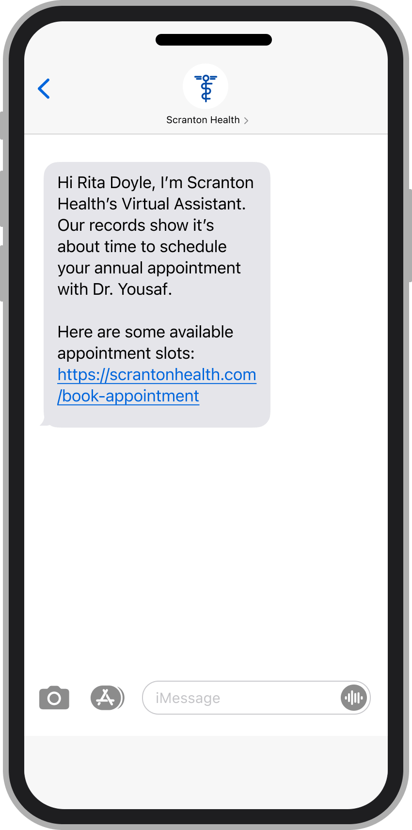 A phone with a text message from a virtual assistant reminding the user to schedule an annual appointment